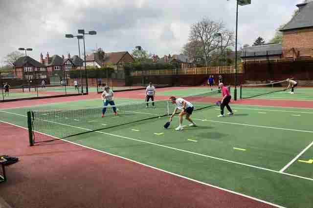 Players enjoying an outdoor game of pickleball Nottingham on community courts”