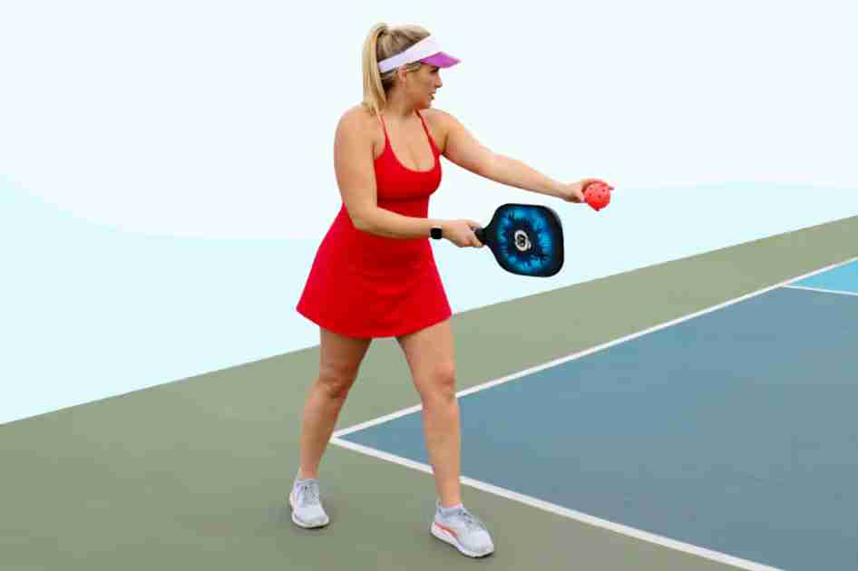 Player demonstrating pickleball serve rules by hitting an underhand serve on an outdoor court.